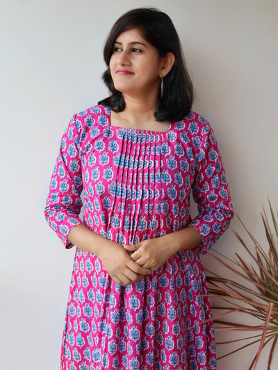 Pink Cotton Kurta Set with Pintuck details, floral prints, 3/4th Sleeves, Side Pocket, flattering Aline kurta with matching straight Cotton Pants.