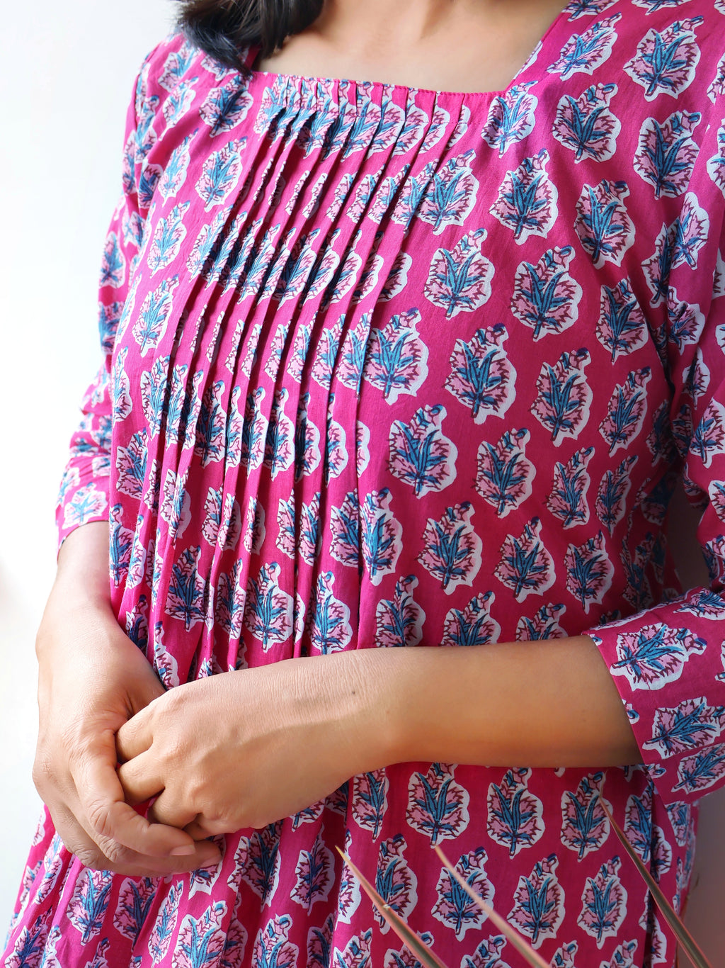 Pink Cotton Kurta Set with Pintuck details, blue floral prints, 3/4th Sleeves, Side Pocket, flattering Aline kurta with matching straight Cotton Pants.