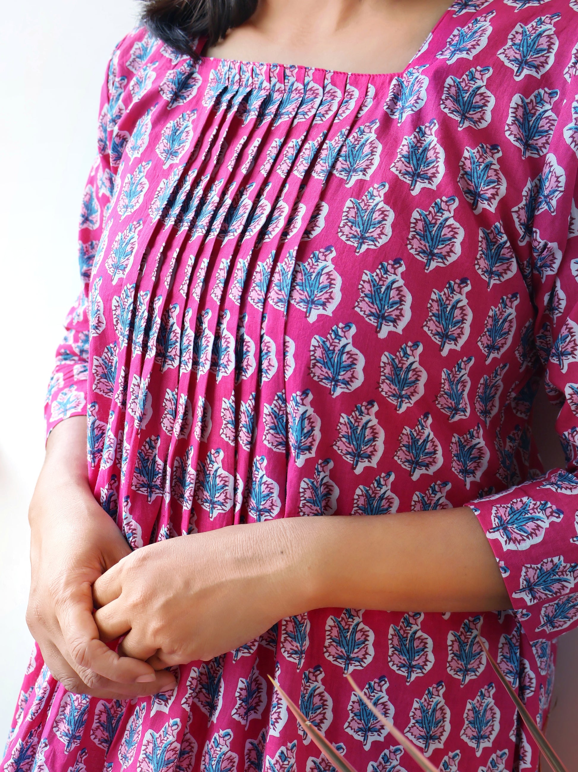 Pink Cotton Kurta Set with Pintuck details, blue floral prints, 3/4th Sleeves, Side Pocket, flattering Aline kurta with matching straight Cotton Pants.