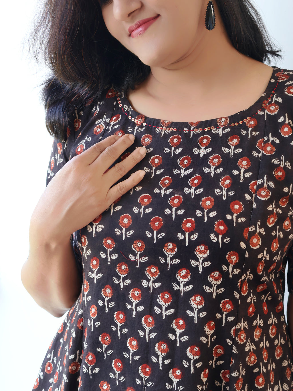 Close-up of Bagru print and sequin work on black cotton kurta