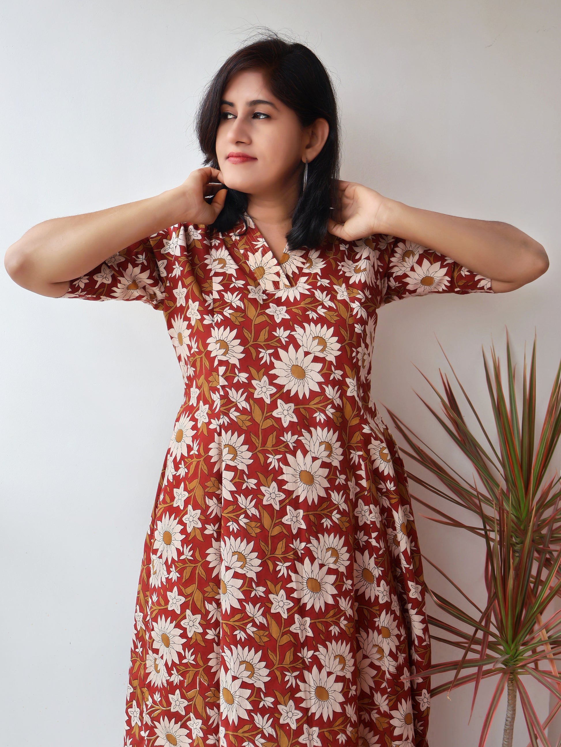Reddish Gerbera Bagru hand block printed kurta in 100% pure cotton, featuring white floral motifs, panel A-line silhouette, collar V-neck, elbow sleeves, and a side pocket—crafted for breathable comfort and timeless everyday elegance.