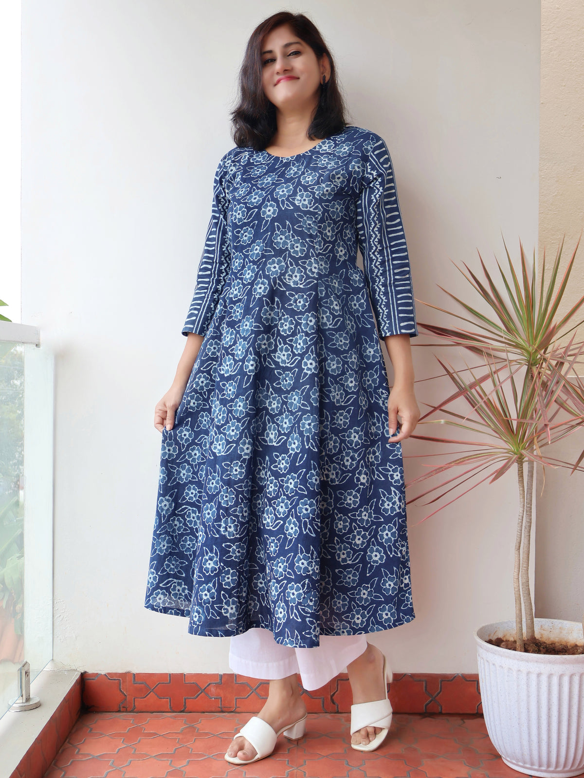 Women wearing Indigo Natural Dyed Floral Dabu Hand Block Printed Cotton Kurta with paneled style and striped sleeves