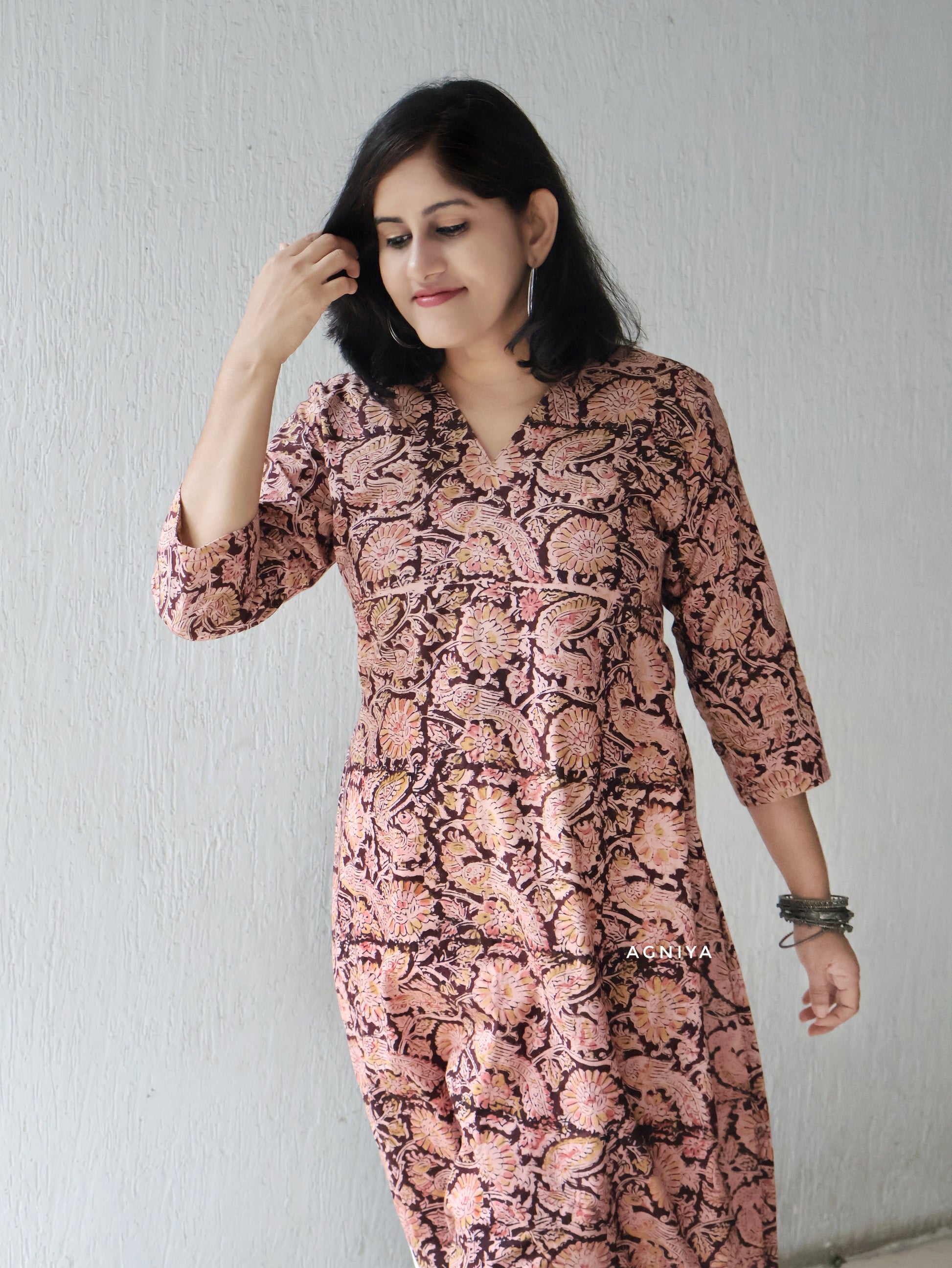 Woman wearing a Kalamkari Kurta in a plain backgroundi 