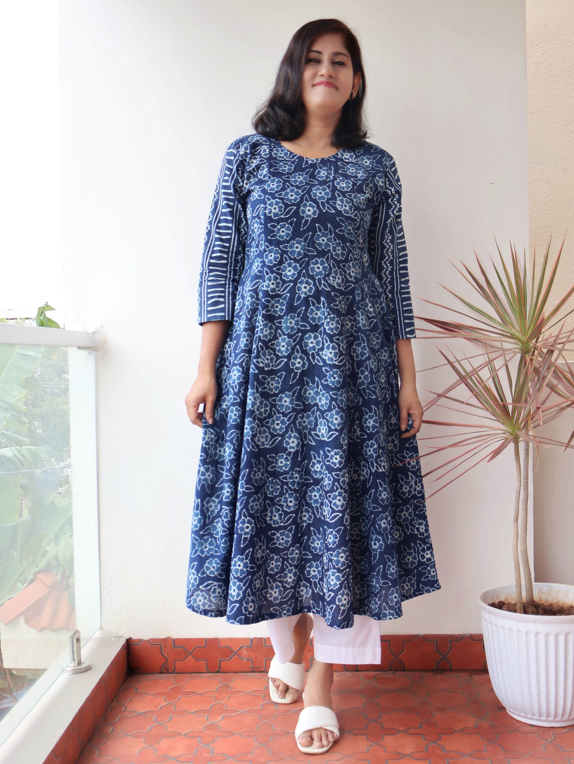 Women wearing Indigo Natural Dyed Floral Dabu Hand Block Printed Cotton Kurta with paneled style and striped sleeves