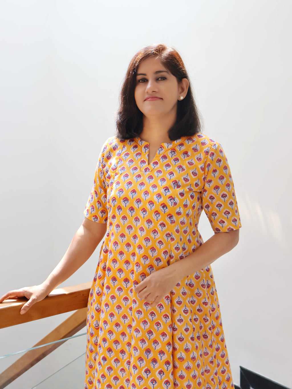 Close-up of hand-embroidered V-neckline on yellow Sanganeri block print cotton kurta
