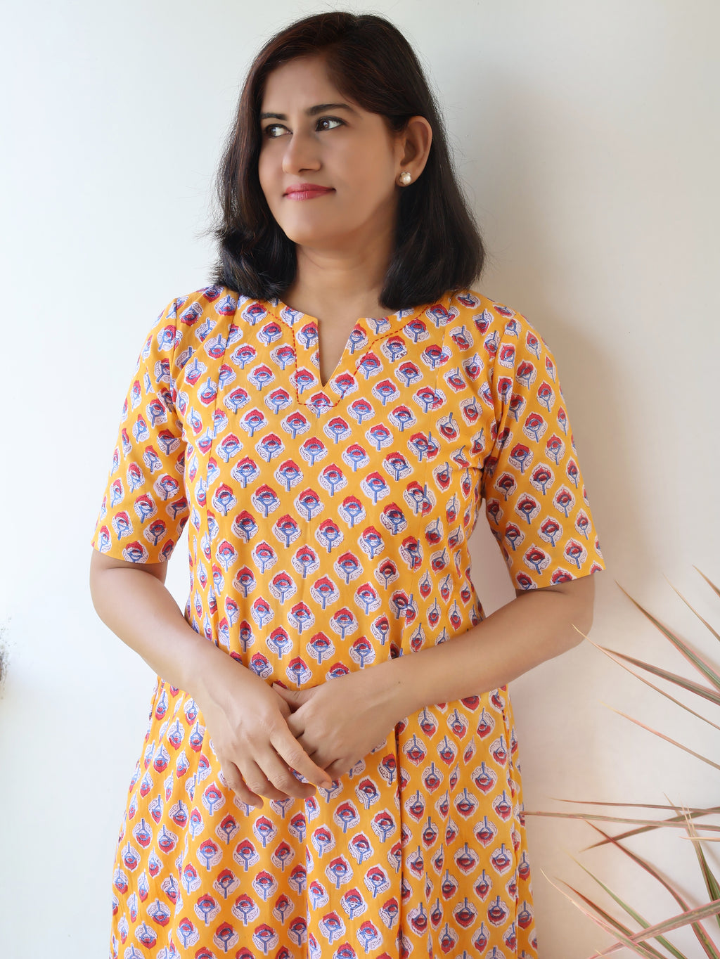 Women wearing Yellow breathable cotton kurta with Sanganeri hand block print and soft paneled fit
