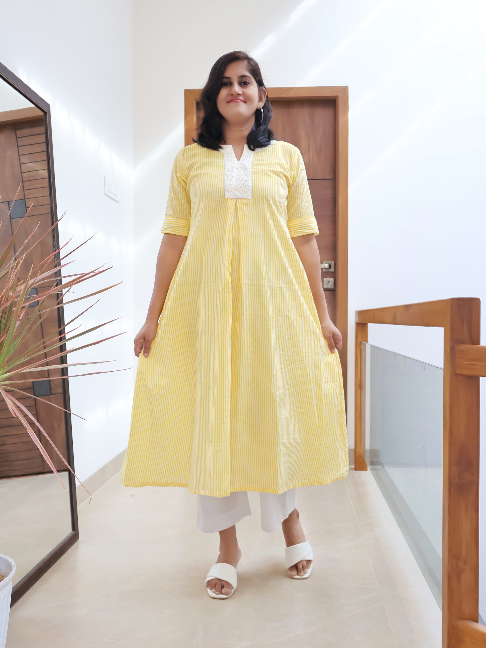 Yellow printed pure cotton A-line kurta featuring white Hakoba patchwork yoke