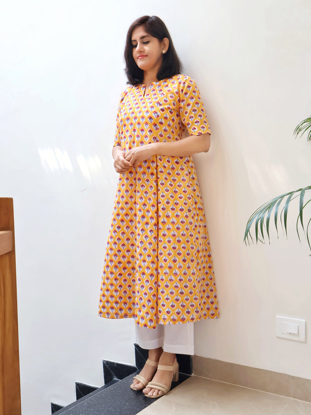Yellow Sanganeri hand block kurta with red butti print and hand-embroidered V-neckline