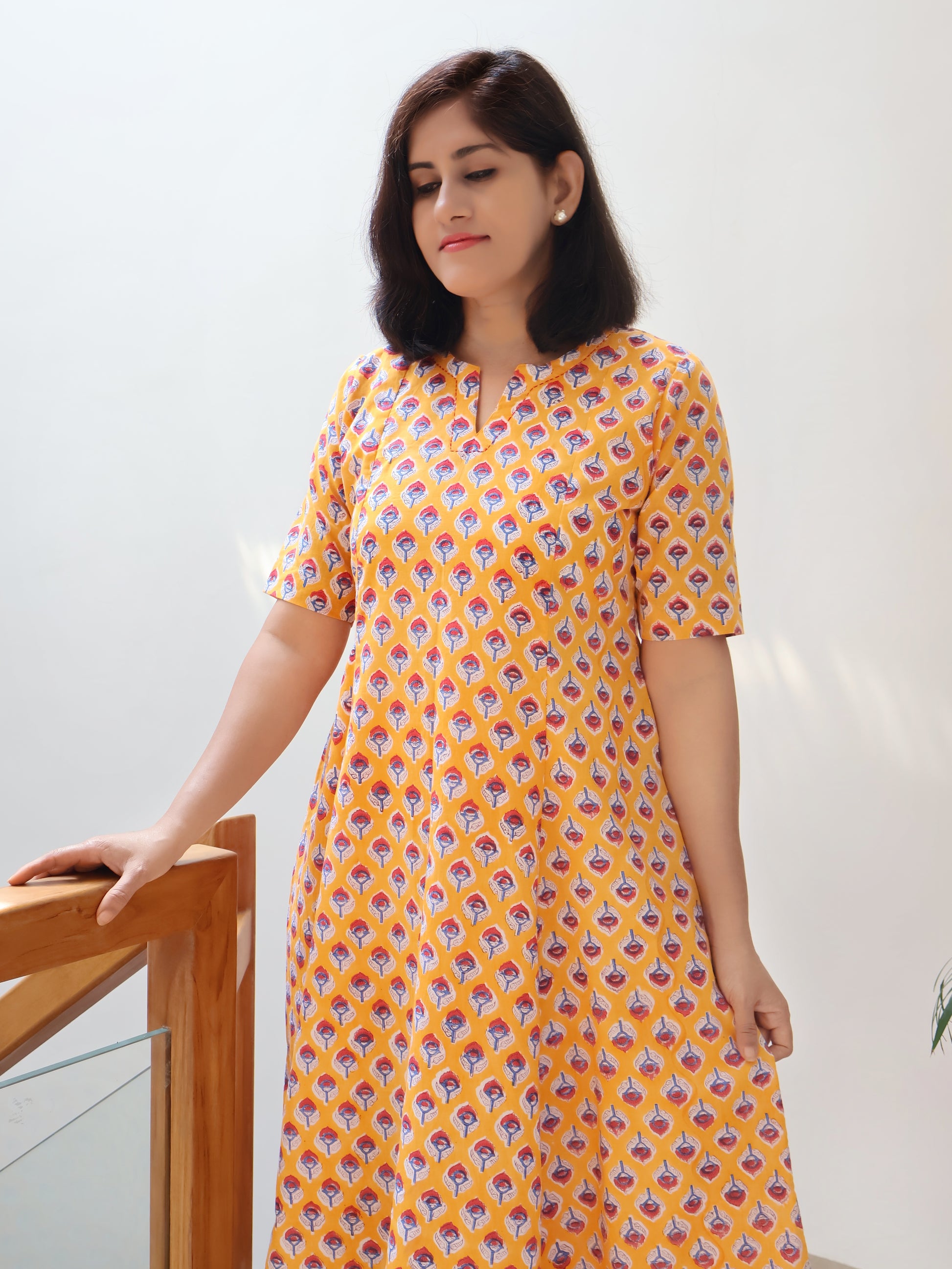 Women wearing yellow pure cotton kurta with Sanganeri hand block red butti motifs
